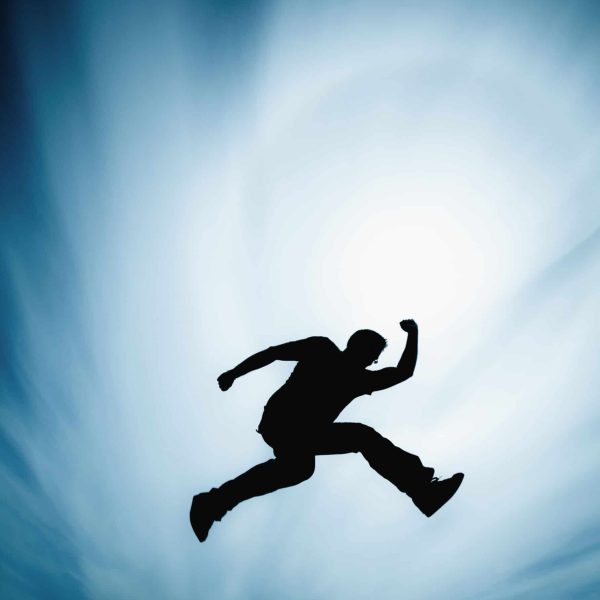 man-jumping-against-cloudy-sky-2022-03-04-05-39-50-utc
